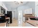 Kitchen view displays white cabinets and stainless steel appliances with tiled flooring at 1802 Hagen Ct, St Cloud, FL 34771
