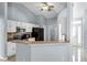 Kitchen showcases white cabinetry, black appliances, tile floors, and a breakfast bar at 1802 Hagen Ct, St Cloud, FL 34771
