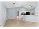 Open-concept living space featuring tile floors, a kitchen with appliances, and a dining area with a ceiling fan at 1802 Hagen Ct, St Cloud, FL 34771