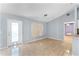 Spacious living room with tile floors, a bright window, and access to the dining area and outdoor patio at 1802 Hagen Ct, St Cloud, FL 34771