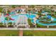 A stunning aerial view of the community pool, lazy river, playground, and well-maintained landscaping at 1864 Nice Ct, Kissimmee, FL 34747