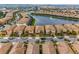 Community aerial view featuring a neighborhood with beautiful homes, a lake, and well-maintained streets at 1864 Nice Ct, Kissimmee, FL 34747