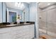 Bathroom featuring double sinks, sleek granite countertops and a stylish tiled shower enclosure at 1864 Nice Ct, Kissimmee, FL 34747
