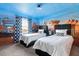 The themed bedroom offers two twin beds and muraled walls for a unique and playful atmosphere at 1864 Nice Ct, Kissimmee, FL 34747