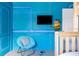 The themed bedroom offers a blue chair and muraled walls for a unique and playful atmosphere at 1864 Nice Ct, Kissimmee, FL 34747