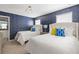 Bedroom featuring two twin beds, starry wallpaper and a view of the ensuite bathroom at 1864 Nice Ct, Kissimmee, FL 34747