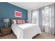 Bright bedroom with a comfortable bed, modern decor, and natural light from the windows at 1864 Nice Ct, Kissimmee, FL 34747