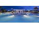 Inviting community pool featuring covered lounge areas, a splash pad, and ample seating for residents at 1864 Nice Ct, Kissimmee, FL 34747