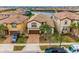 Inviting two-story home with a well-manicured lawn and brick-paved driveway, complemented by a serene lake view at 1864 Nice Ct, Kissimmee, FL 34747
