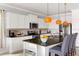 Modern kitchen features stainless steel appliances, granite counters, and island with seating at 1864 Nice Ct, Kissimmee, FL 34747
