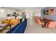 Spacious living room with modern décor, open to a well-equipped kitchen and dining area for entertaining at 1864 Nice Ct, Kissimmee, FL 34747
