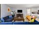 Cozy living room with plush blue sofa, entertainment center, and large window at 1864 Nice Ct, Kissimmee, FL 34747