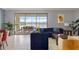 Cozy living room with comfortable seating, opening to a scenic patio with a tranquil lake view at 1864 Nice Ct, Kissimmee, FL 34747