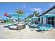Relaxing pool area with lounge chairs, sun umbrellas, and lush tropical landscaping for resort-style living at 1864 Nice Ct, Kissimmee, FL 34747