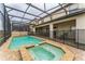 Inviting screened-in pool and spa offer a relaxing retreat, with a safety fence for added security at 1864 Nice Ct, Kissimmee, FL 34747