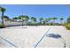 Outdoor sand volleyball court with manicured sand and palm trees is great for an active lifestyle at 1864 Nice Ct, Kissimmee, FL 34747