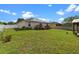 Spacious backyard features a well-kept lawn, privacy fence, deck, gazebo, and solar panels at 1942 N Portillo Dr, Deltona, FL 32738
