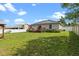 Wide backyard with a large lawn, fence, deck, and gazebo, is ideal for Gathering fun at 1942 N Portillo Dr, Deltona, FL 32738