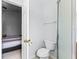 Bathroom featuring a toilet, towel rack, and glass-doored shower for a clean and modern look at 1942 N Portillo Dr, Deltona, FL 32738