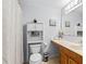 Bathroom with a vanity, mirror, toilet with storage, and shower curtain for privacy at 1942 N Portillo Dr, Deltona, FL 32738