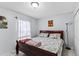 Cozy bedroom features a wood bed frame with floral bedding, a window, and a closet at 1942 N Portillo Dr, Deltona, FL 32738
