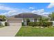 Charming single Gathering home featuring solar panels, well-maintained landscaping, and a two-car garage at 1942 N Portillo Dr, Deltona, FL 32738