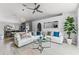 Bright, open concept living room with a modern ceiling fan, neutral colors, and durable wood-look flooring at 1942 N Portillo Dr, Deltona, FL 32738