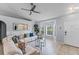 Bright living room with a large window, modern ceiling fan, neutral colors, and durable wood-look flooring at 1942 N Portillo Dr, Deltona, FL 32738