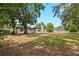 Expansive backyard featuring lush greenery, mature trees, and charming home exterior at 2015 N Hastings St, Orlando, FL 32808