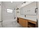 Modern bathroom boasts sleek vanity, updated light fixtures, and tiled shower at 2015 N Hastings St, Orlando, FL 32808