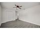 Neutral bedroom featuring modern gray flooring, ceiling fan, and closet at 2015 N Hastings St, Orlando, FL 32808