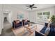 Bright living room featuring modern furniture, decor, ceiling fan, and gray-toned wood floors at 2015 N Hastings St, Orlando, FL 32808