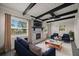 Living room with modern decor, fireplace, ceiling fan, and large windows letting in lots of natural light at 2015 N Hastings St, Orlando, FL 32808