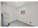 Bright utility room with gray flooring, window, and water heater at 2015 N Hastings St, Orlando, FL 32808