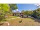 Spacious backyard with mature trees, and a screened lanai offer privacy and a tranquil setting at 203 Red Bud Ct, Lake Mary, FL 32746