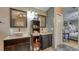 Elegant bathroom with double sinks, decorative tiles, and a view into the bedroom at 203 Red Bud Ct, Lake Mary, FL 32746