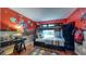 bedroom with red accent wall with cartoon characters, a lofted bed, and wood flooring at 203 Red Bud Ct, Lake Mary, FL 32746