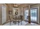 Cozy dining area with wrought iron chairs and a glass table, adjacent to the pool view at 203 Red Bud Ct, Lake Mary, FL 32746