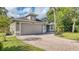 Charming single-Gathering home featuring a paver driveway, attached garage, and lush landscaping at 203 Red Bud Ct, Lake Mary, FL 32746