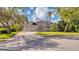 Charming single-Gathering home featuring a paver driveway, attached garage, and lush landscaping at 203 Red Bud Ct, Lake Mary, FL 32746