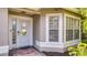Stylish front door with sidelights and decorative glass, complemented by lush landscaping at 203 Red Bud Ct, Lake Mary, FL 32746