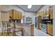 Kitchen featuring stainless steel appliances, granite countertops, and breakfast bar seating at 203 Red Bud Ct, Lake Mary, FL 32746