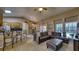 Living room with open-concept layout, connecting the kitchen, dining area, and outdoor pool view at 203 Red Bud Ct, Lake Mary, FL 32746