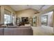 Spacious living room with a large television, neutral color palette, and vaulted ceilings at 203 Red Bud Ct, Lake Mary, FL 32746