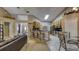Open-concept living room and kitchen area with skylight, granite countertops, and stainless appliances at 203 Red Bud Ct, Lake Mary, FL 32746