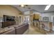 Open-concept living room featuring high ceilings, tile floors, and kitchen with breakfast bar at 203 Red Bud Ct, Lake Mary, FL 32746