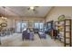 Open living area with leather sofa, dining area, and access to the outdoor patio via French doors at 203 Red Bud Ct, Lake Mary, FL 32746