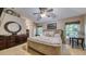 Spacious main bedroom featuring a large bed, ceiling fan, and tranquil views at 203 Red Bud Ct, Lake Mary, FL 32746