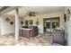Covered patio space boasts an outdoor kitchen, ceiling fan, and access to the refreshing pool at 203 Red Bud Ct, Lake Mary, FL 32746