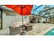 Outdoor living with screened-in pool, fire table, and comfortable seating for enjoying the Florida sunshine at 203 Red Bud Ct, Lake Mary, FL 32746